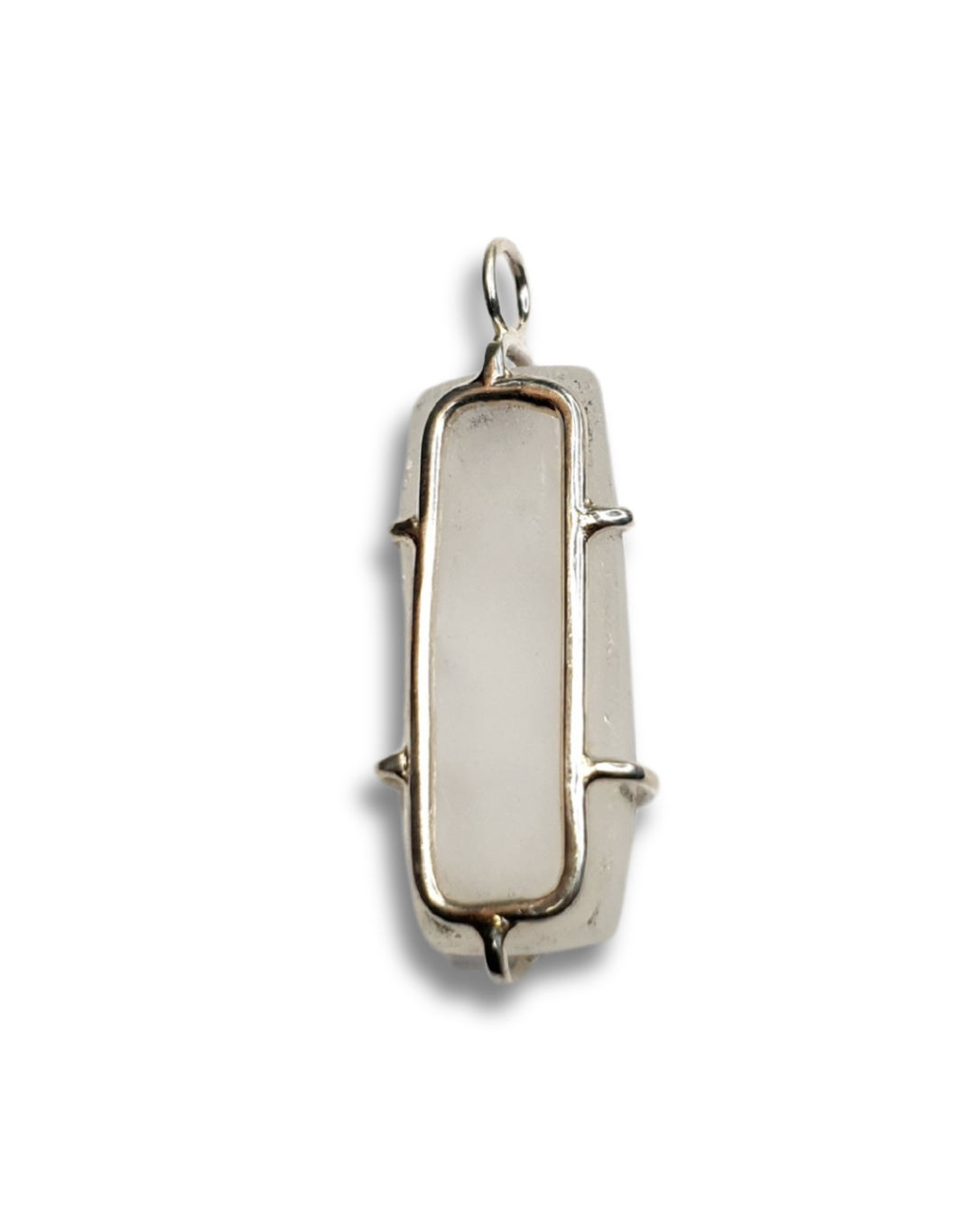 The back of quartz and silver pendant is photographed on a white background. A rectangular silver frame sits against the smooth, flat back while 6 prongs come out from of the edges to hug the stone. There is a circular bail at the top.