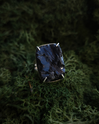 A Sterling silver Ring with a Large Rectangular Rough Cut Smoky Quartz Sits on a bed of luscious green moss