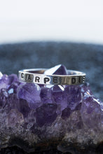 Load image into Gallery viewer, 1 silver rings with the words &quot;carpe diem&quot; stamped into it,. It rests on a chunk of amethyst.
