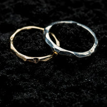 Load image into Gallery viewer, A 9ct gold ore ring and a silver ore ring sitting next each other on a black, sandy background.
