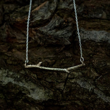 Load image into Gallery viewer, Bronze woodland necklace on a dark, bark background
