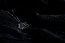 Load image into Gallery viewer, Capricorn zodiac necklace resting against a black background
